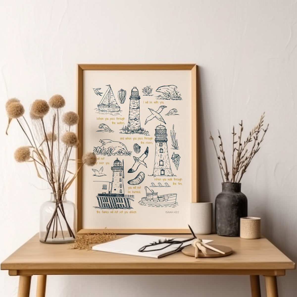 Lighthouse Christian art print with Isaiah 43:2 scripture displayed above a wooden console table with soft neutral coastal styling.