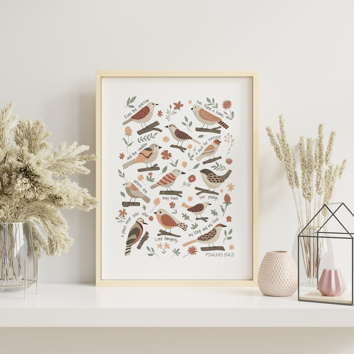 Garden bird Christian print displayed in a light frame with calm neutral decor and soft natural accessories.