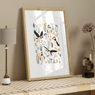 Puffin coastal art print with hand-drawn seabirds and soft botanical details displayed in a light wood frame with neutral styling.