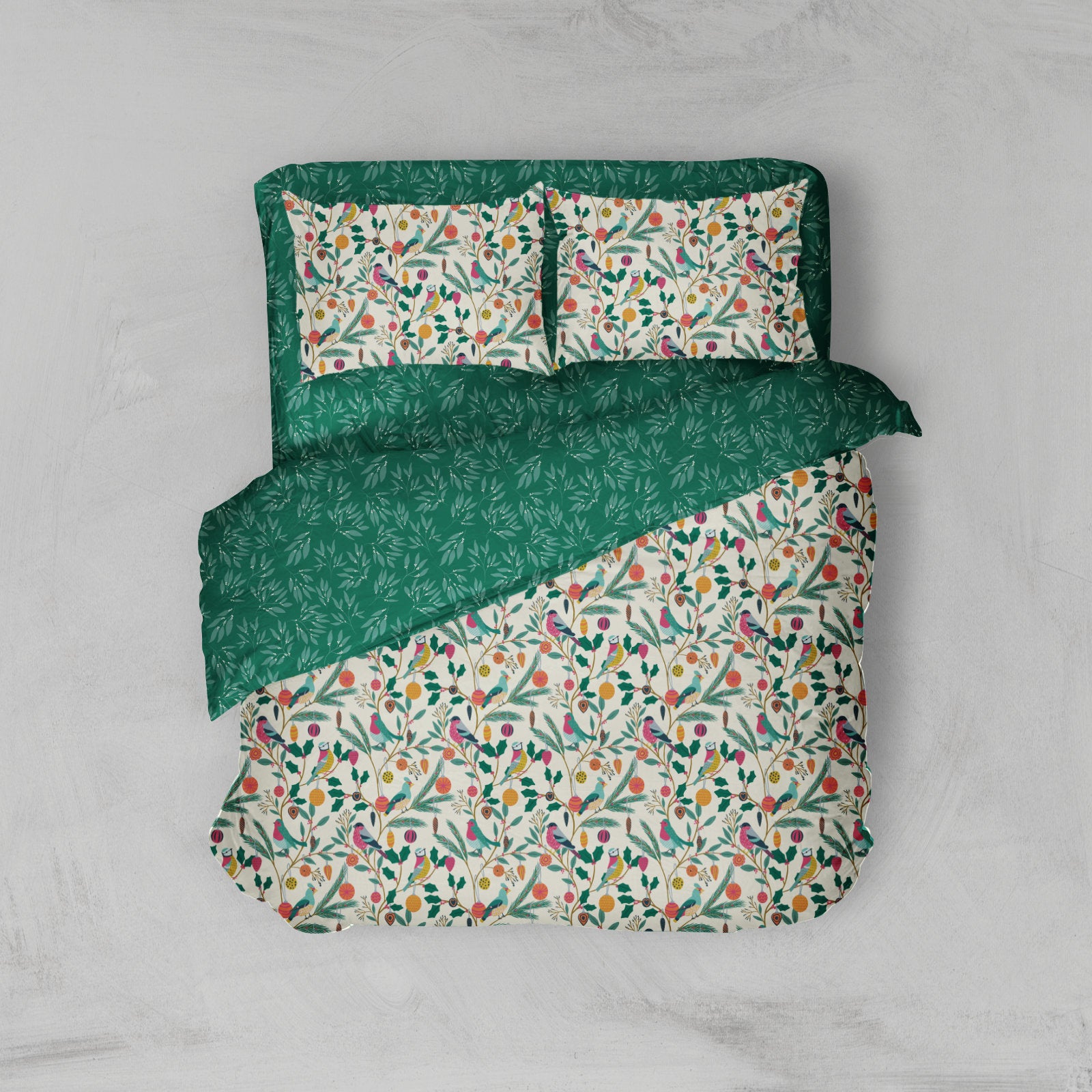 A bedding set featuring a duvet cover and two pillowcases with a botanical and bird pattern. The pattern consists of green leaves, small flowers in orange, pink, and yellow, and birds on an off-white background.