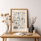 Hand-drawn lighthouse and seascape print displayed above a wooden console table with simple natural decor.