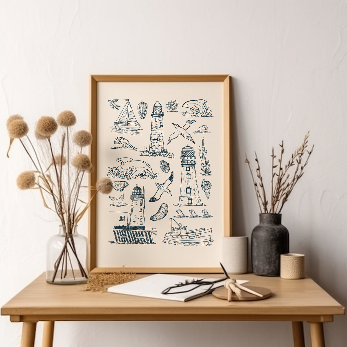 Hand-drawn lighthouse and seascape print displayed above a wooden console table with simple natural decor.
