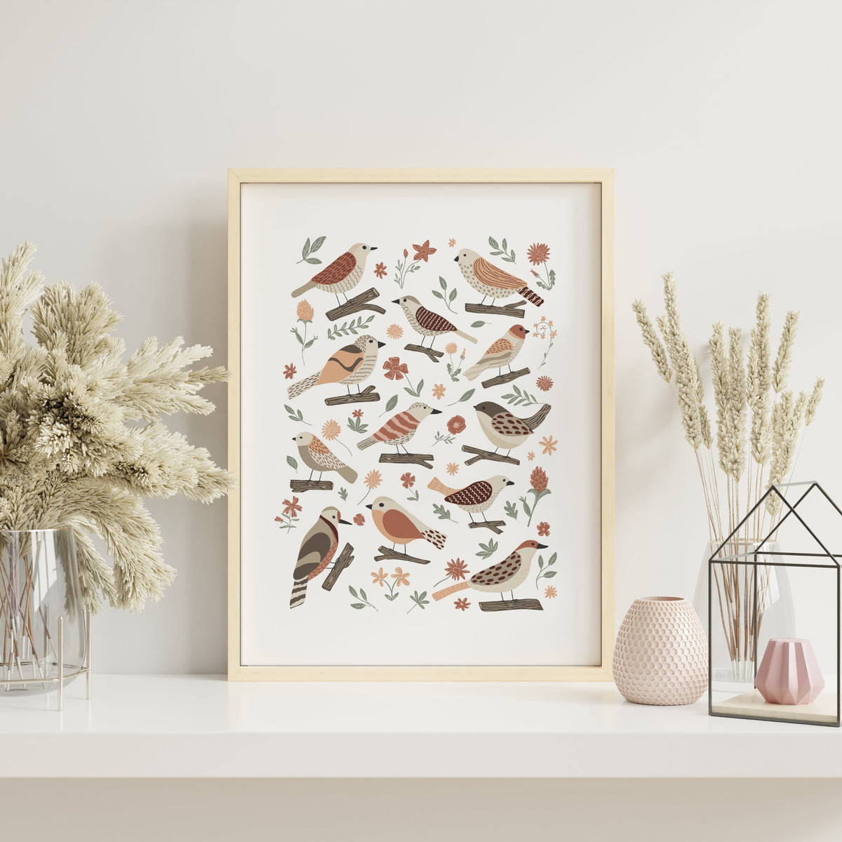 Garden birds art print with hand-illustrated birds, flowers and soft earthy botanical details displayed in a light wood frame.