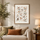 Botanical bird wall art displayed above a neutral sofa in a cosy living room with warm natural textures.