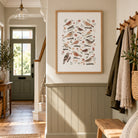 Botanical bird wall art displayed in a warm neutral hallway with wood panelling and cottage-inspired styling.