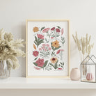 Song of Songs 2:12 floral scripture print with hand-illustrated pastel garden flowers displayed in a light wood frame with soft neutral styling.