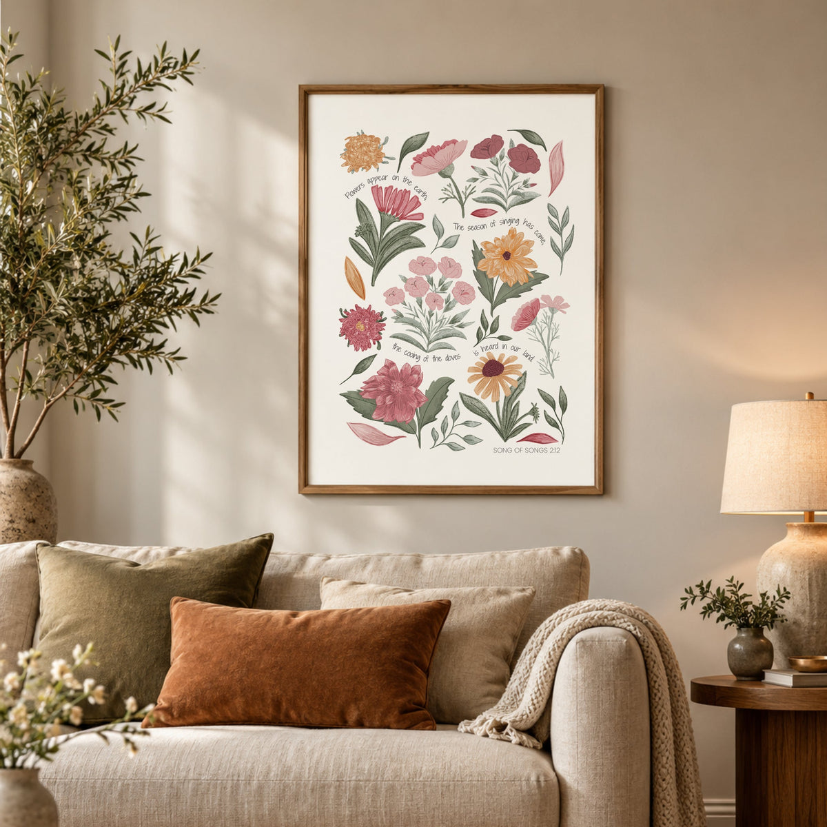 Pastel botanical scripture print displayed above a neutral sofa in a cosy living room with warm earthy decor.