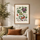 Fruit and botanical wall art displayed above a neutral sofa in a cosy living room with warm earthy decor.
