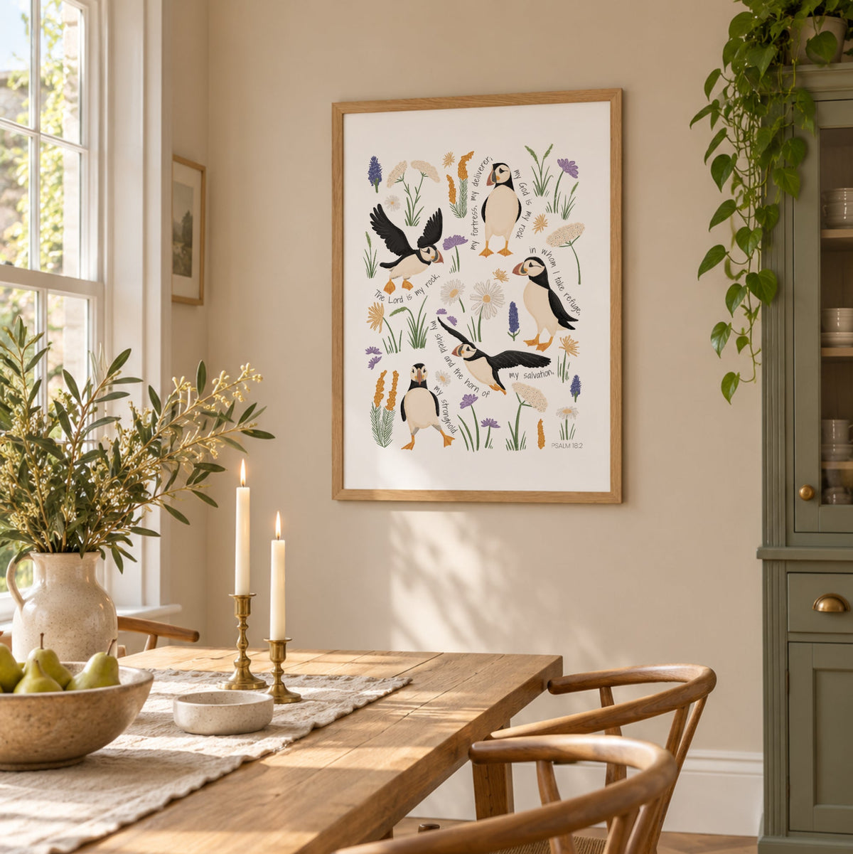 Puffin Christian wall art print with Psalm 18 scripture displayed in a bright dining room with warm wood and natural light.