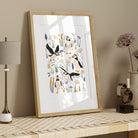 Puffin and sea holly scripture art print in a light wood frame styled above a console table with simple natural accessories.